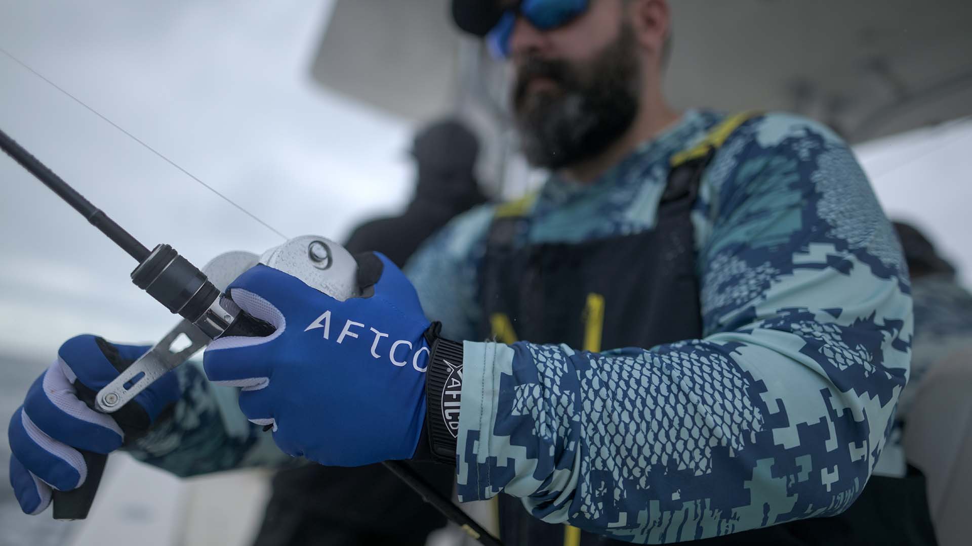 Angler wearing AFTCO JigPro Jigging Gloves