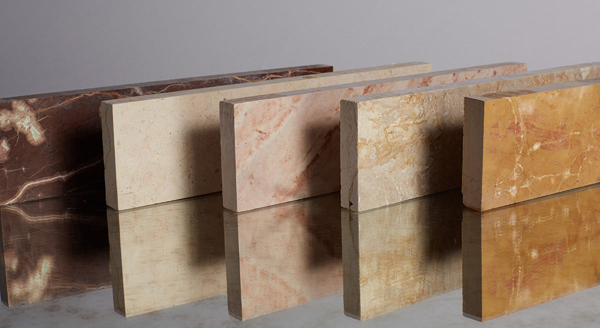 Artistic shot of long rectangular stone tiles standing on their sides in domino formation.