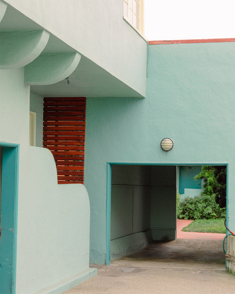 A courtyard with light turquoise walls.