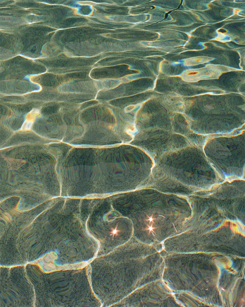 An abstracted photo of water in a pool.