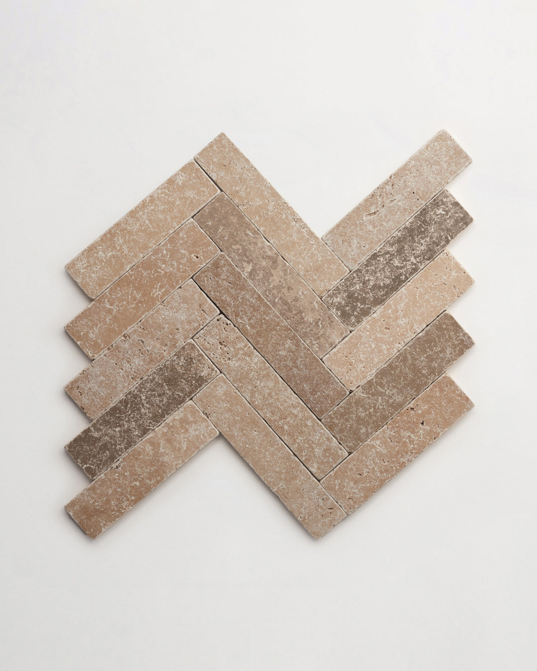 Narrow stone tiles in a herringbone pattern.