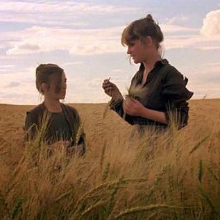 a film still of two girls in a field