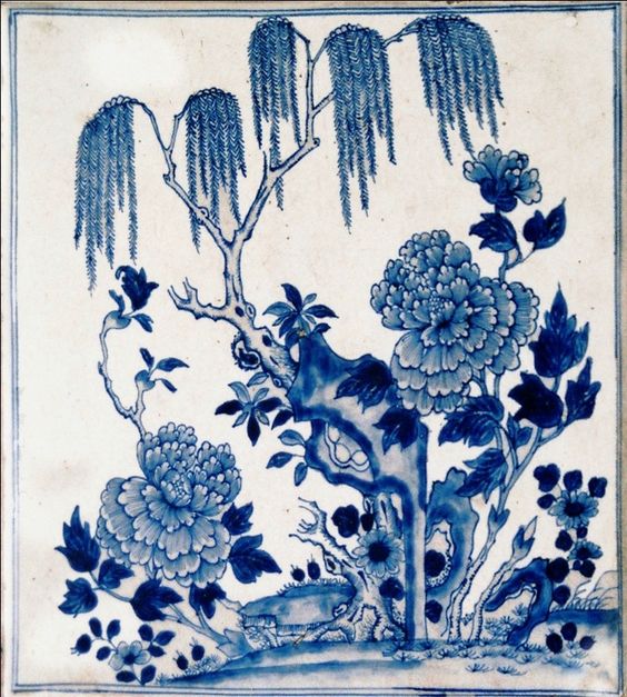 A plate with a blue and white landscape depiction and border.