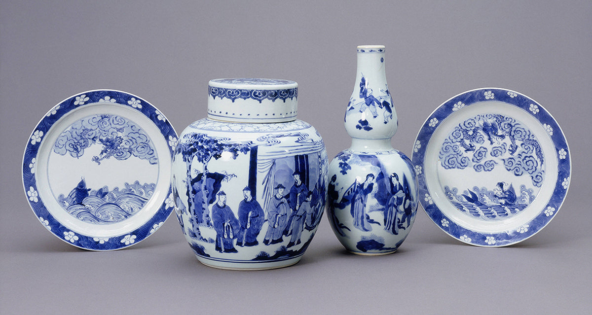 Two plates, one vase and one canister in a blue and white pattern.