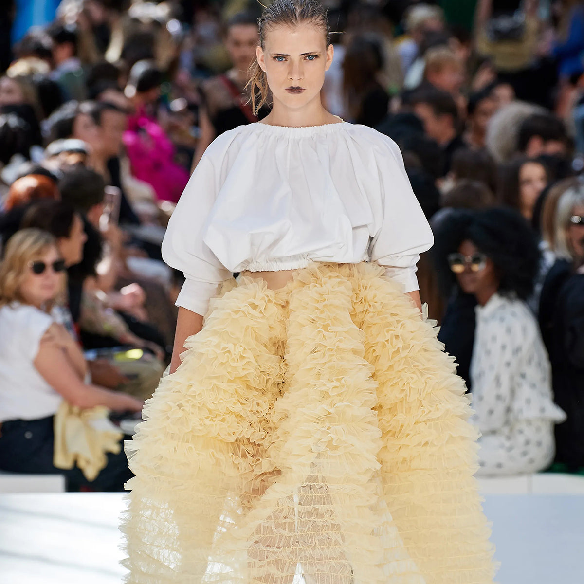 model wearing structured top and dramatic tulle skirts