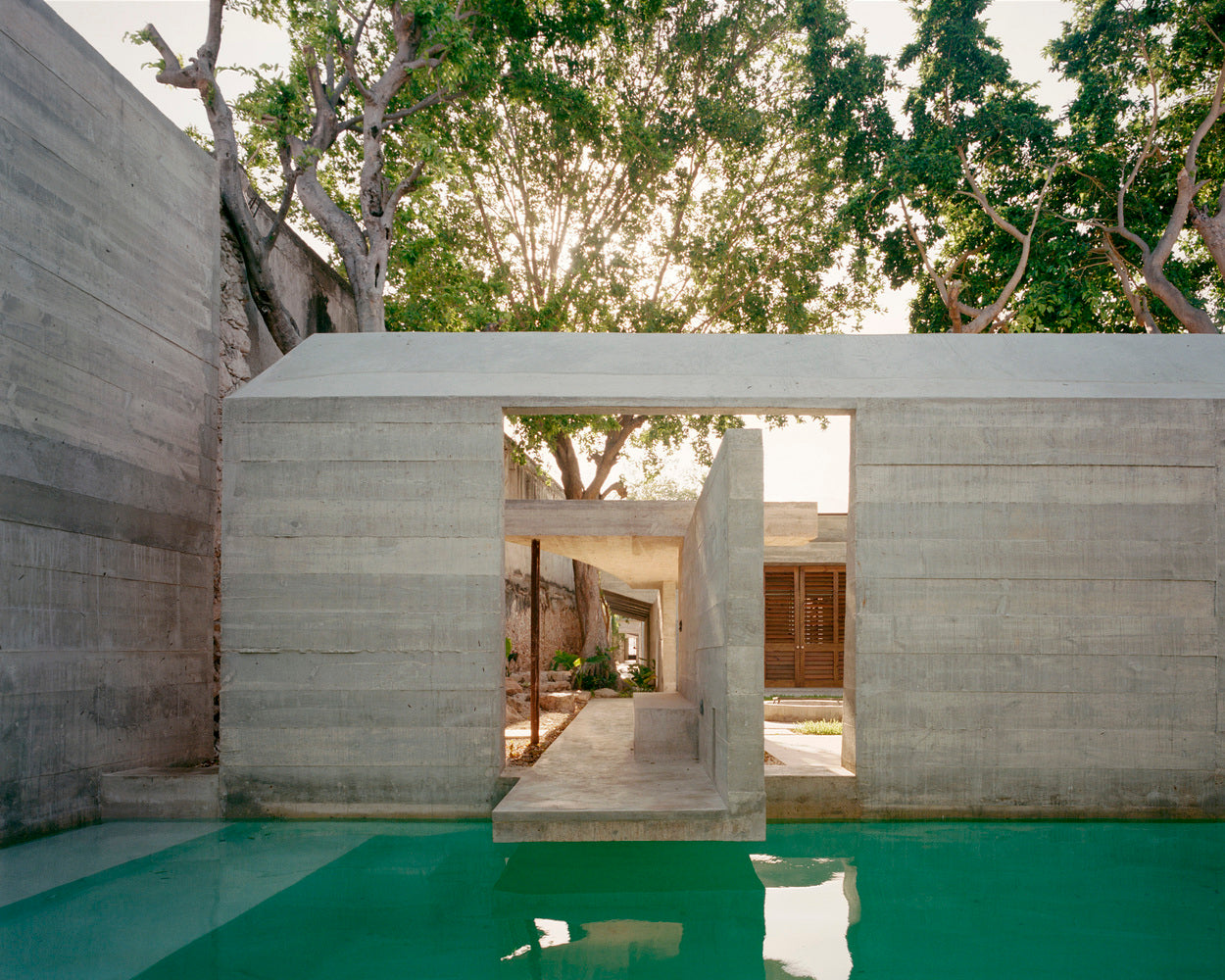 A concrete deck cantilevers over a pool.