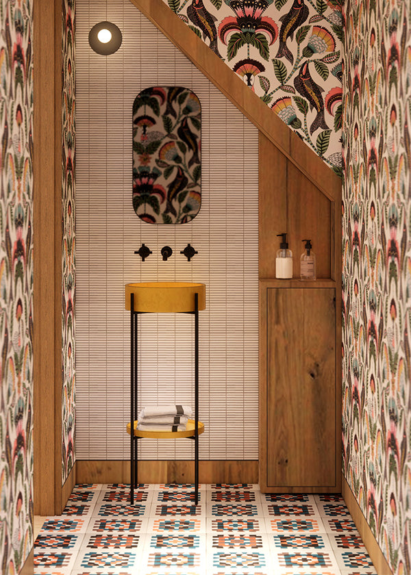 Botanical bathroom with floral wallpaper, wooden beams, and granny square cement tile on the floor.