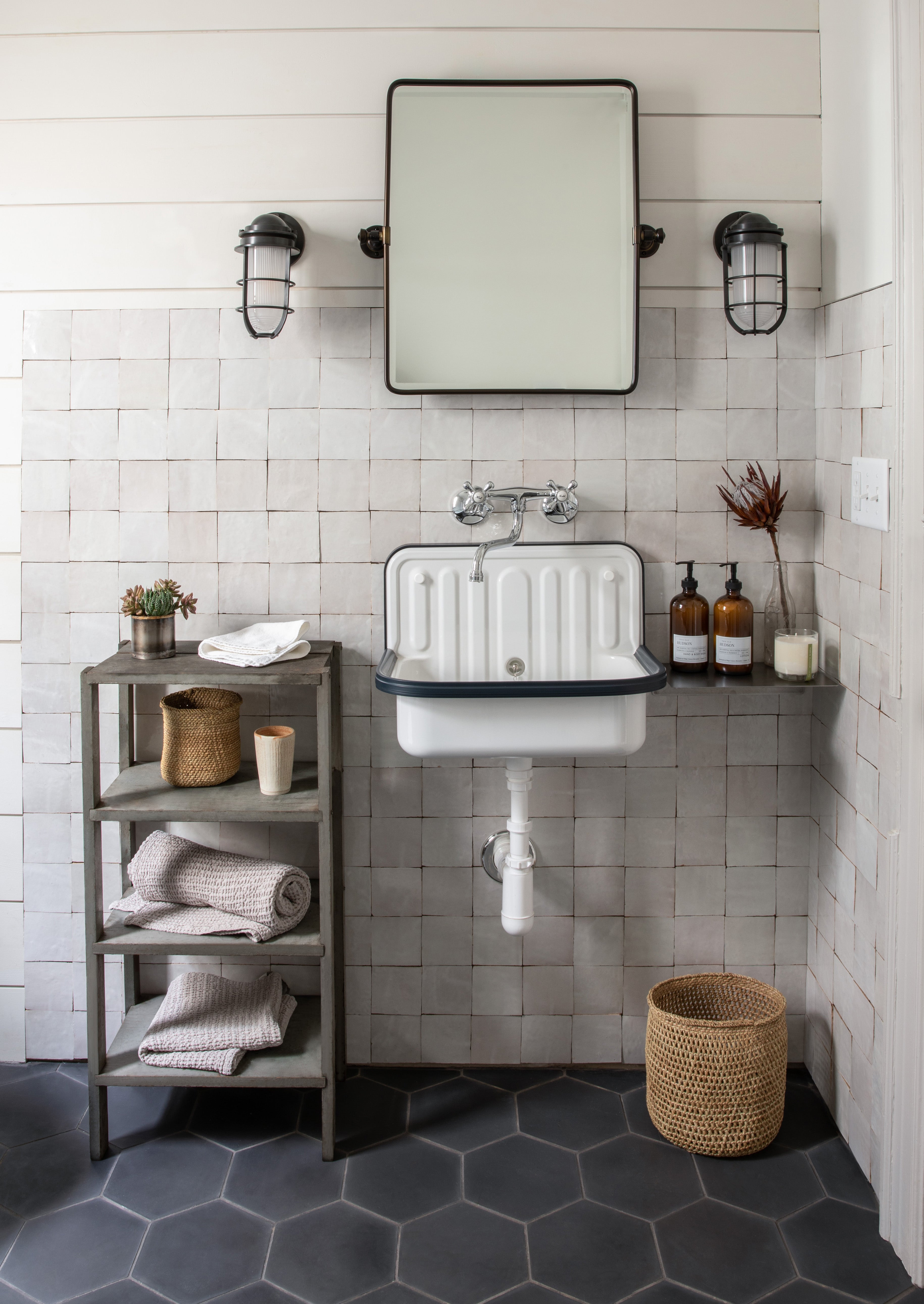 modern farmhouse bathroom with dark tile flooring and white tile backsplash