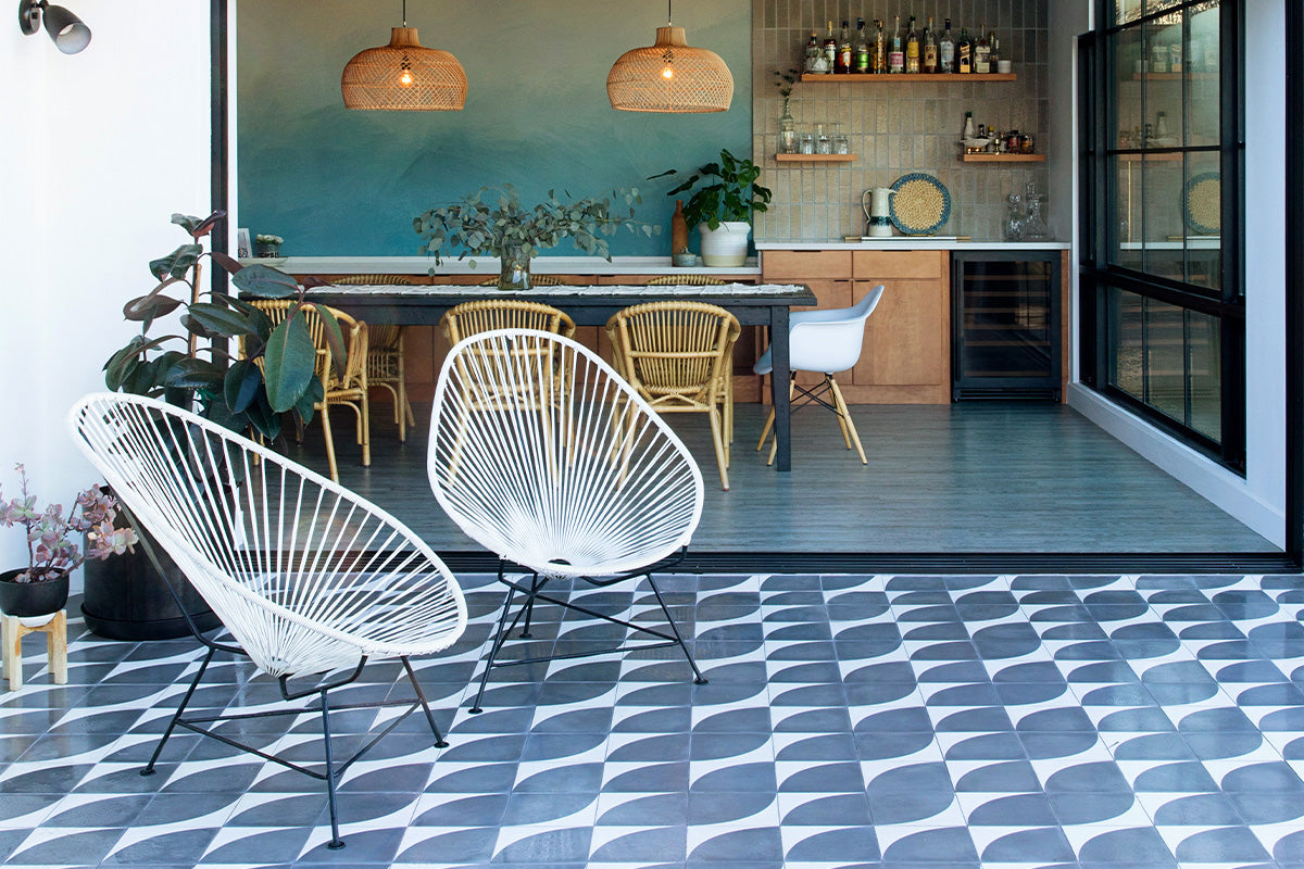 Beautiful indoor kitchen that opens into an outdoor patio with a white and blue patterned cement tile floor.