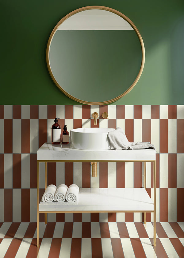 A hallway with white plaster walls and a dark tile floor.