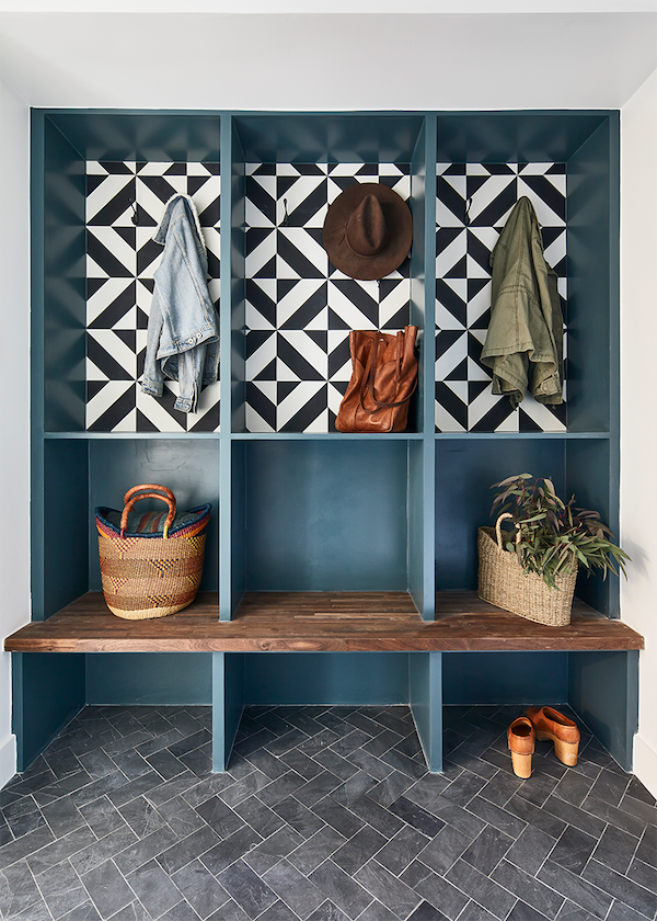 a mudroom with open shelving featuring clé tile cement squares in industrial milan behind the shelves