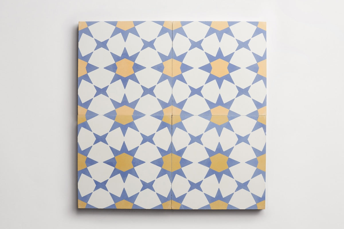 four square blue and yellow patterned moroccan tiles against white background