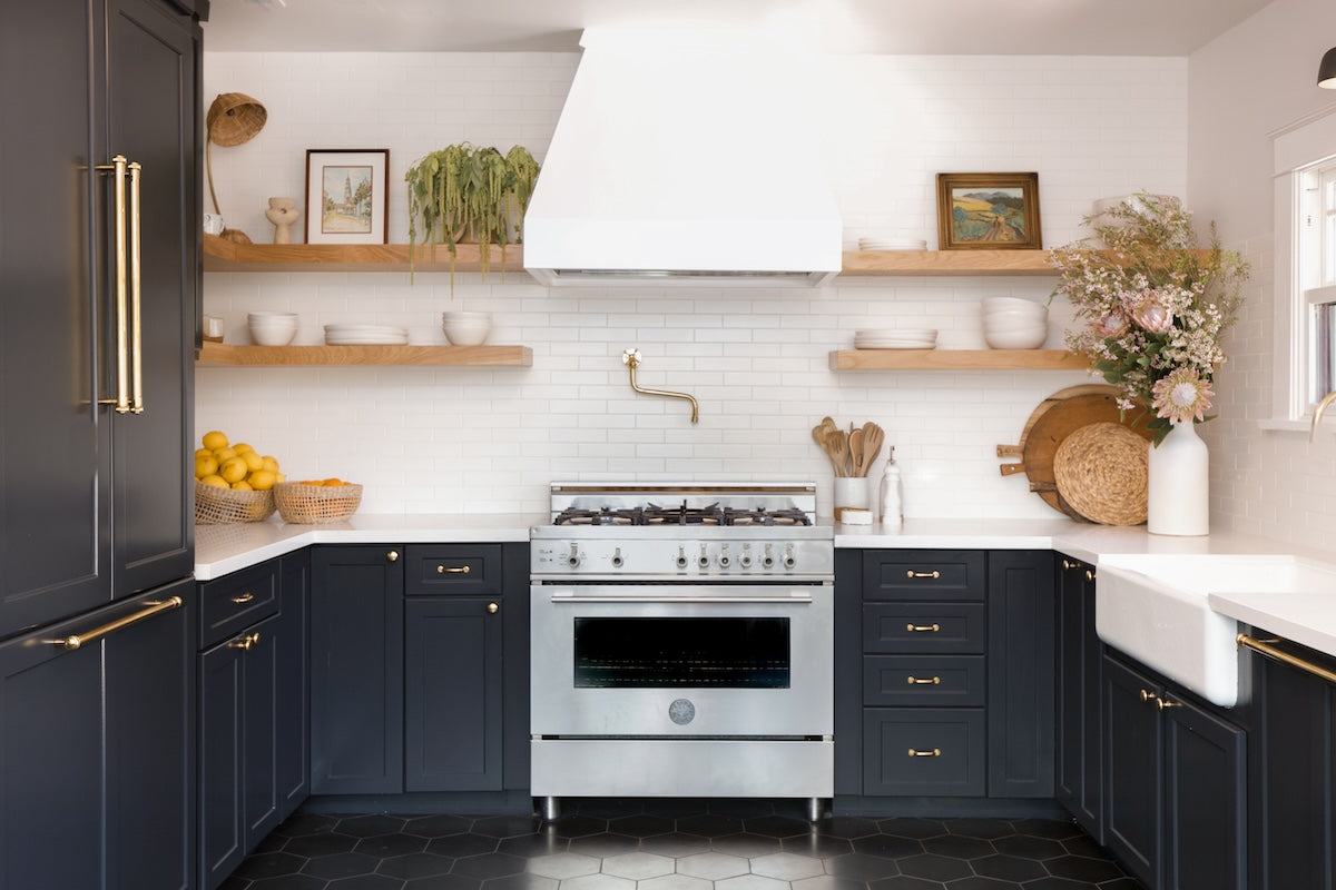 modern stylish kitchen with white subway tile backsplash and dark lower cabinets and floor.