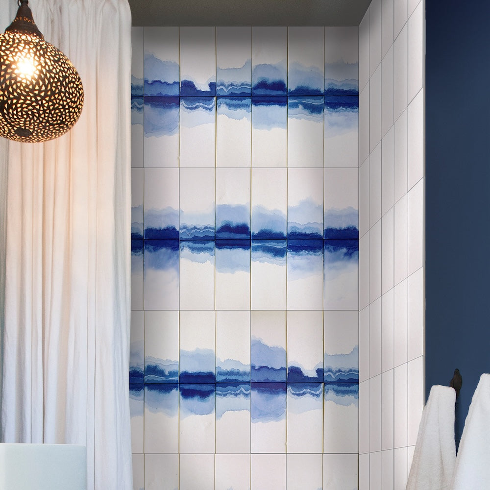 Blue and white bathroom and shibori inspired shower tile wall, white curtain, and navy painted wall.