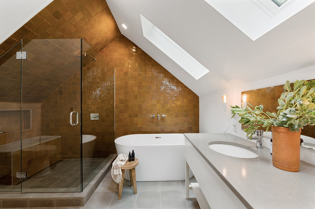 a modern bathroom and shower featuring clé zellige square tile on the shower walls and bathroom backsplash