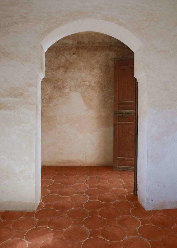 moroccan style archway with bright red raw terracotta tile floor