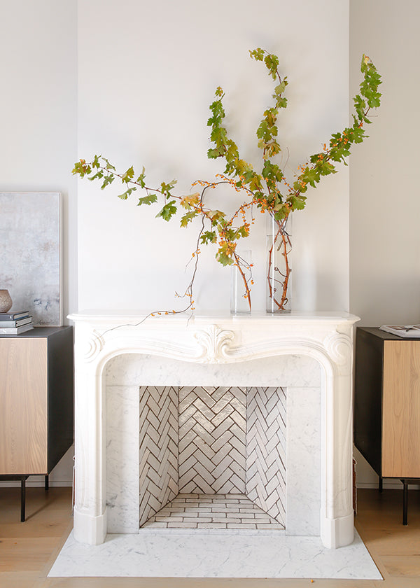 a tiled fireplace featuring clé zellige bejmat tiles in weathered white