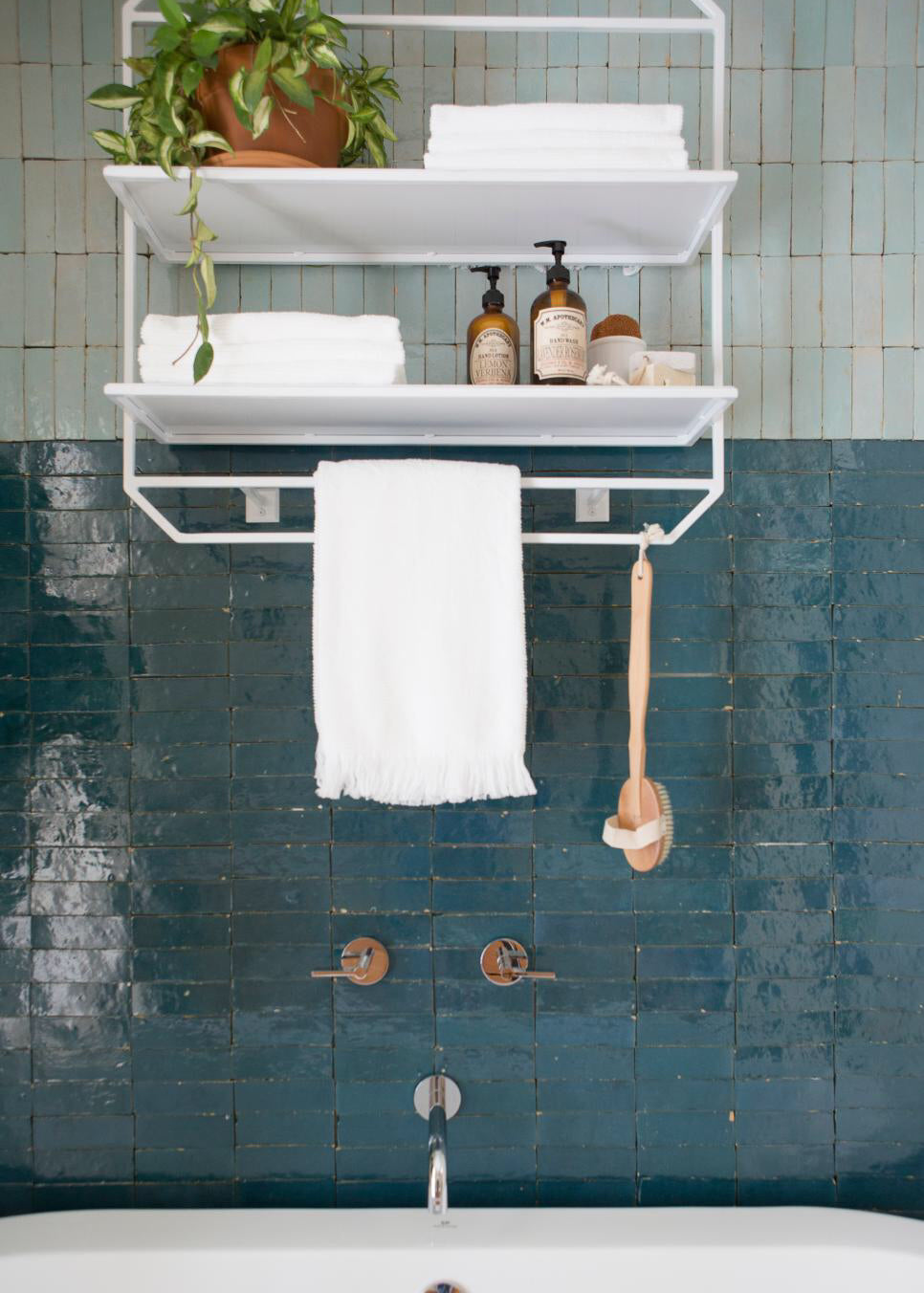 a colorful shower features clé zellige bejmat tile in fired opal on the shower wall