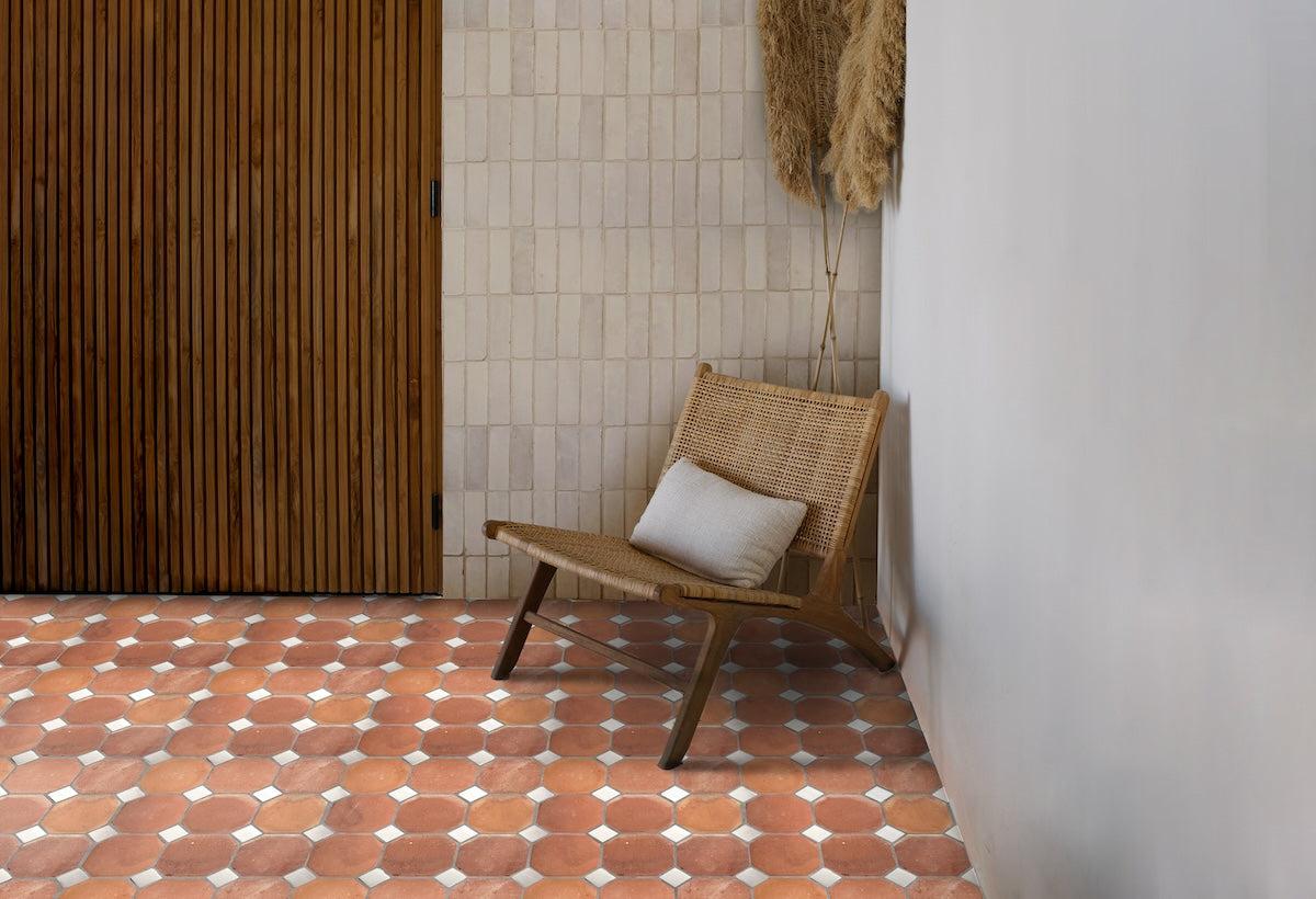 Earth colored living room with terracotta and white zellige tile floor and white zellige wall.