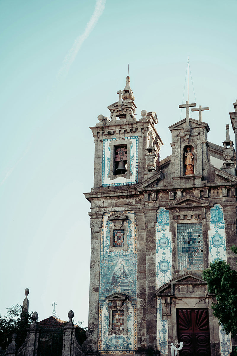 A dramatic church with blue and white tile on the facade and towers.