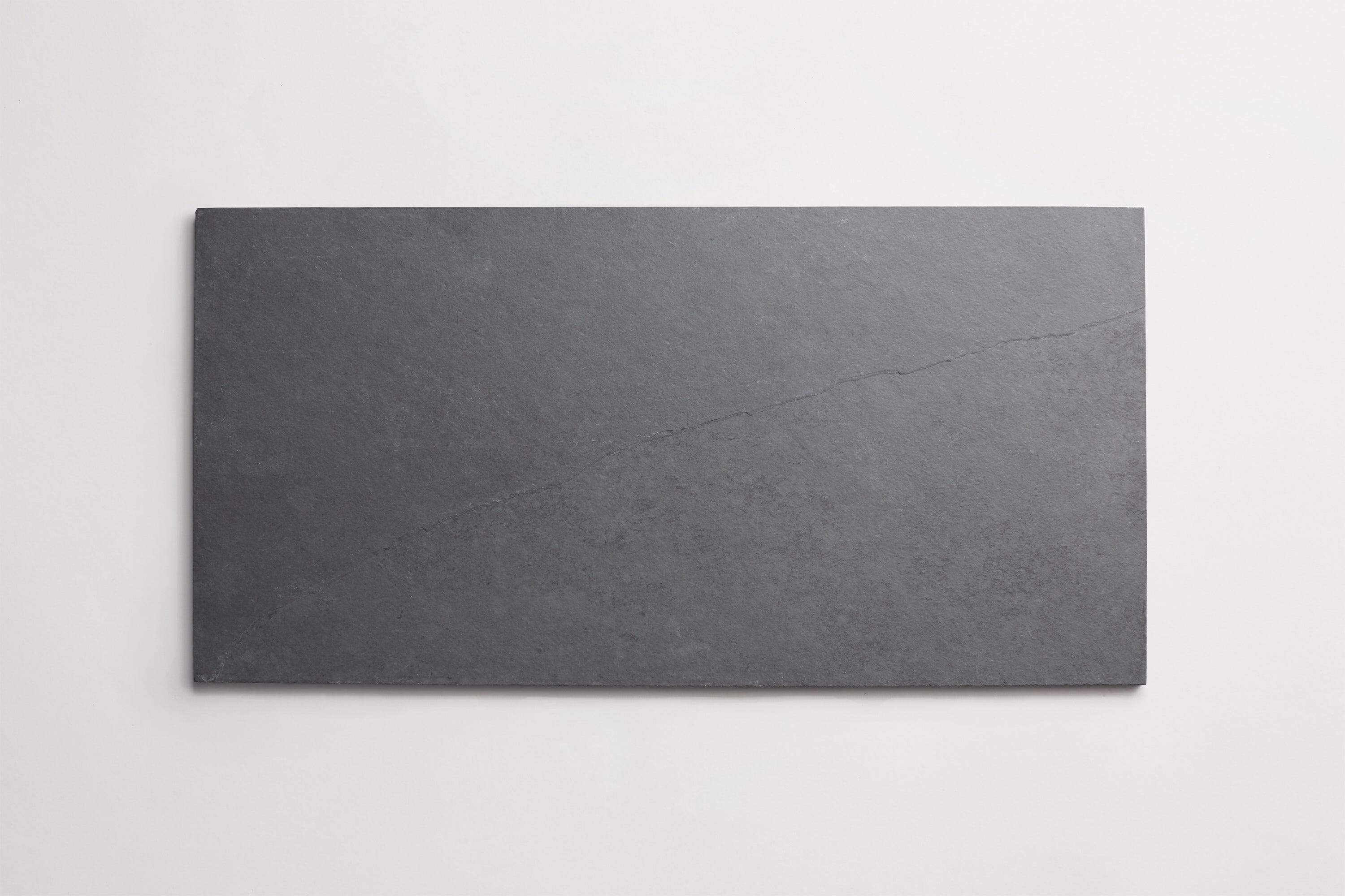 Rectangular natural slate stone tile against a white background.