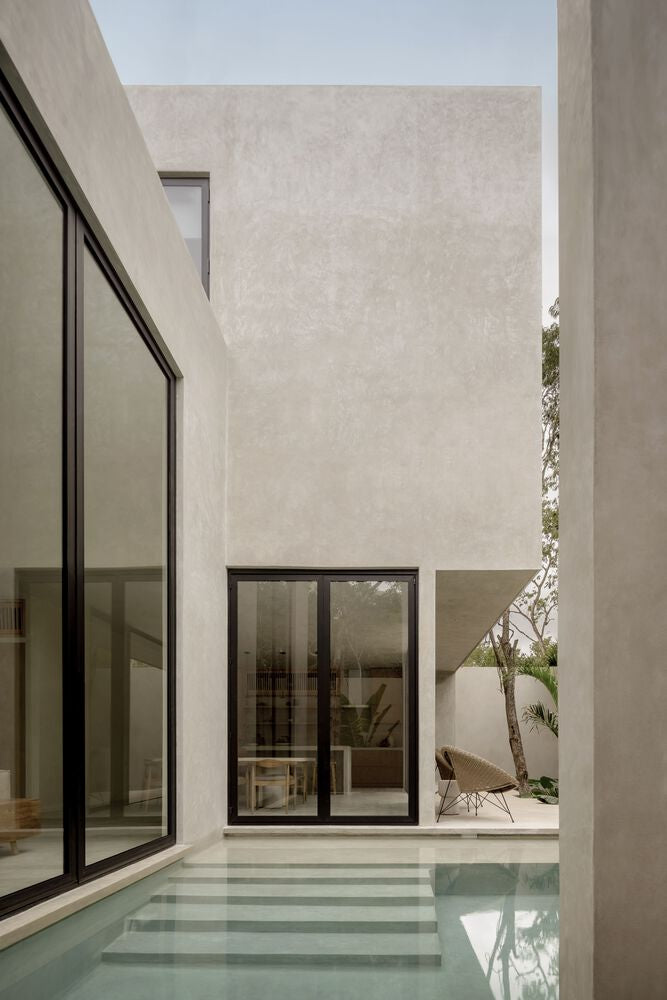 Plaster walls around a pool with wide steps.