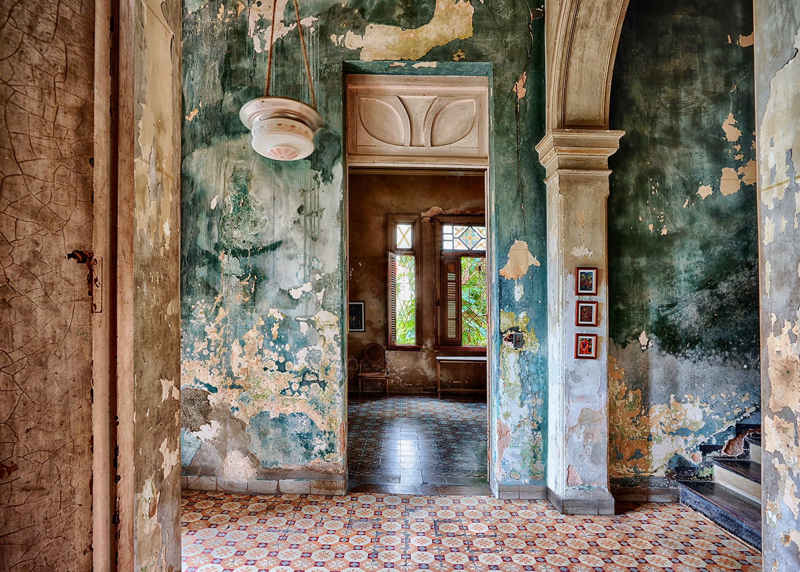 Richly textured walls with arches and an ornate floor.