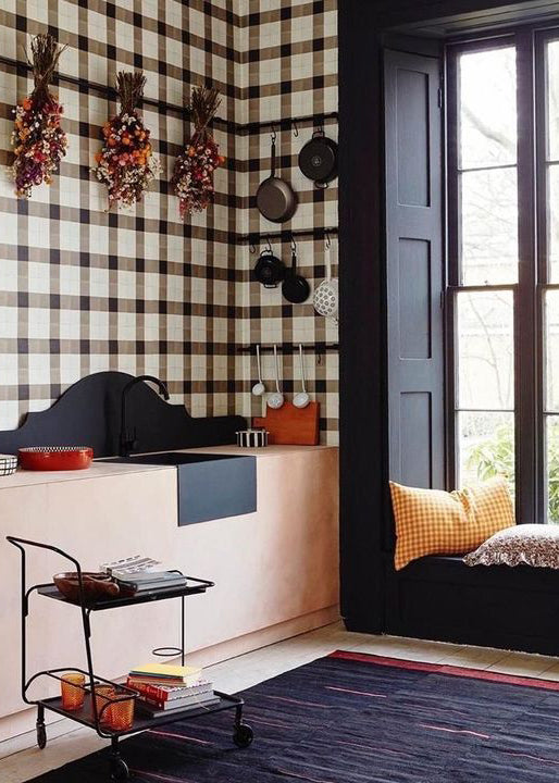 A kitchen with cement tile walls in a plaid pattern.