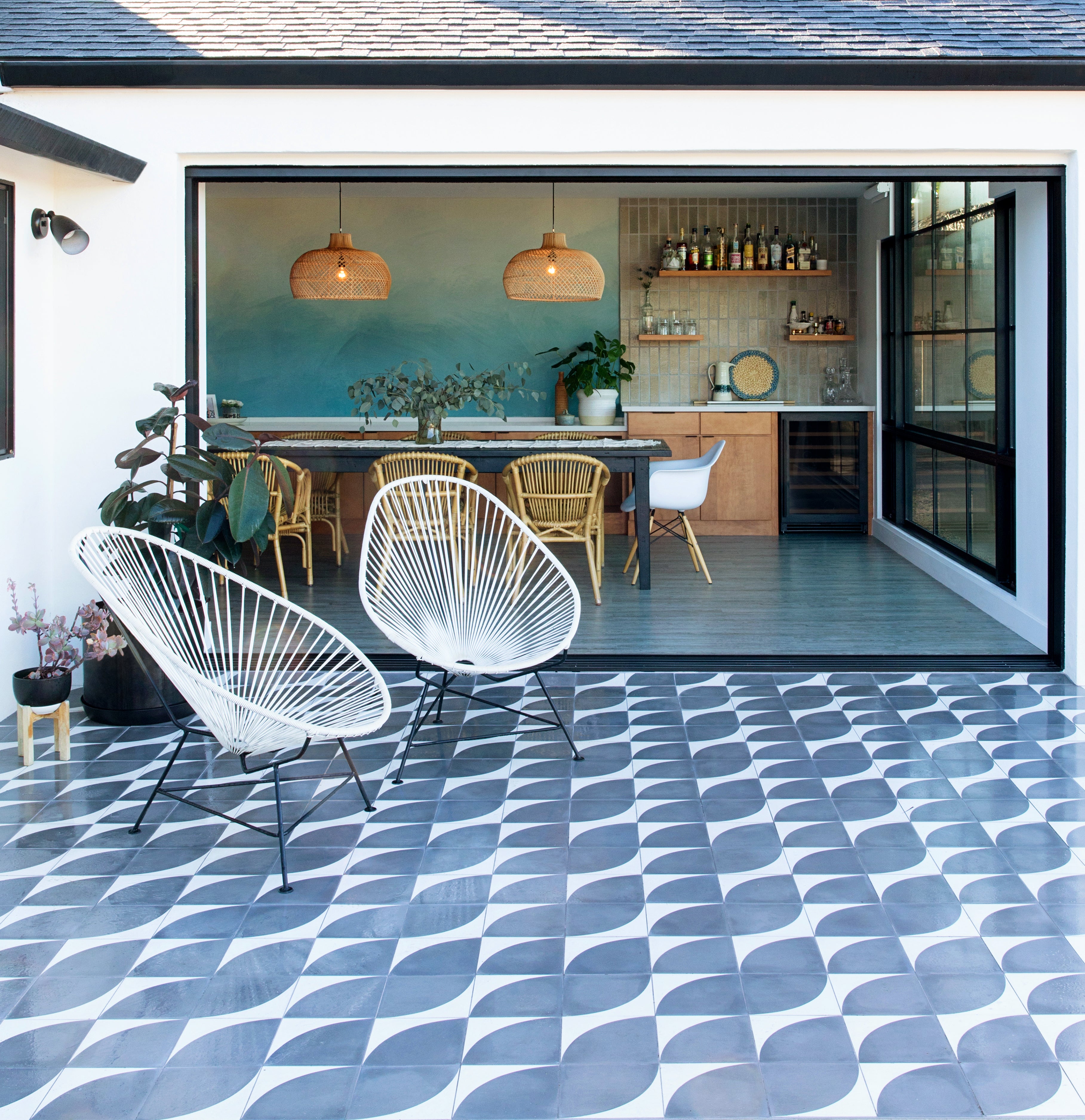 Square tiles with an arc design create a sweeping pattern on a patio floor.