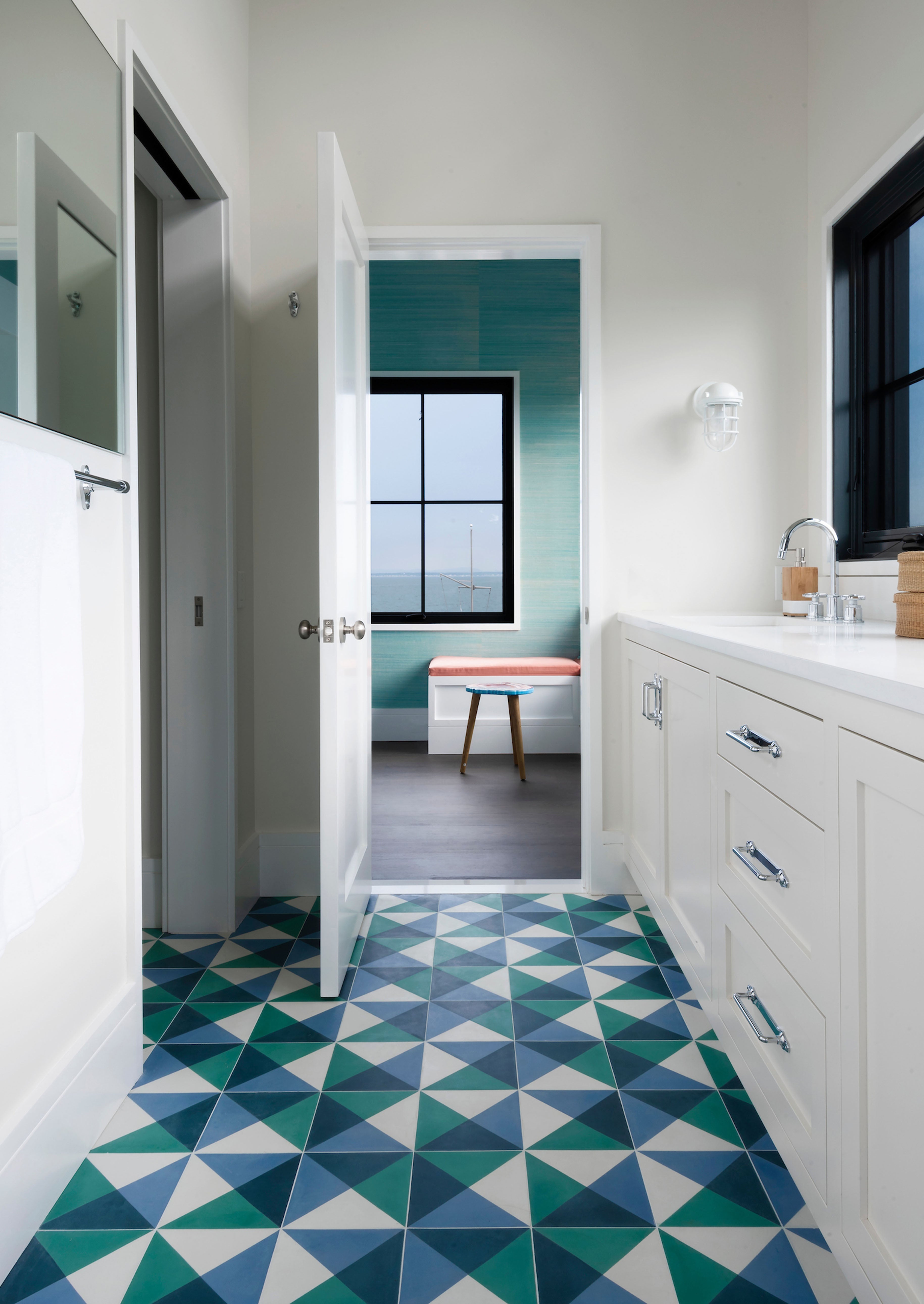 Blue, green and white cement tiles on a kitchen floor.