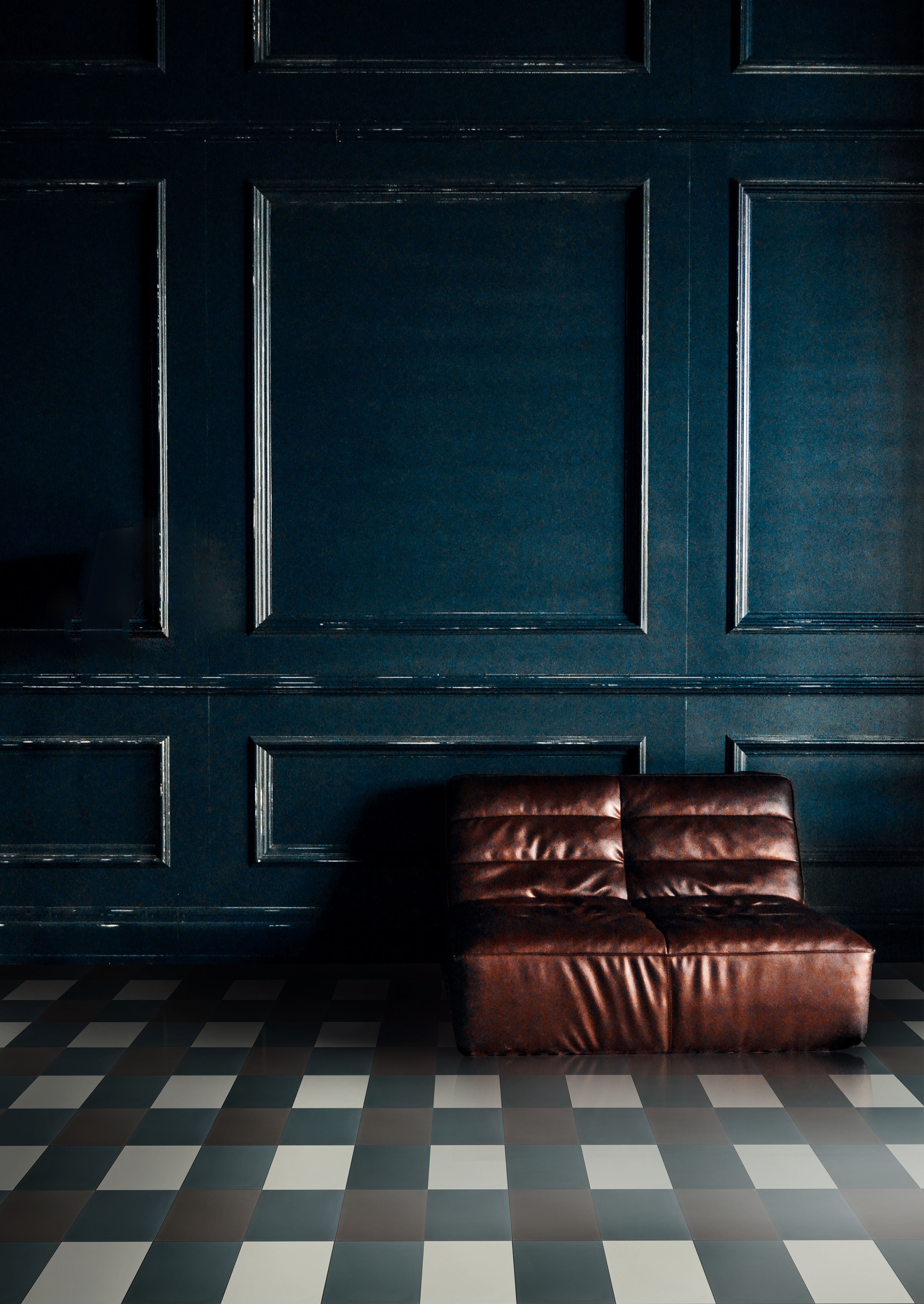 Square cement tiles in an oversized plaid pattern in front of a turquoise wall.