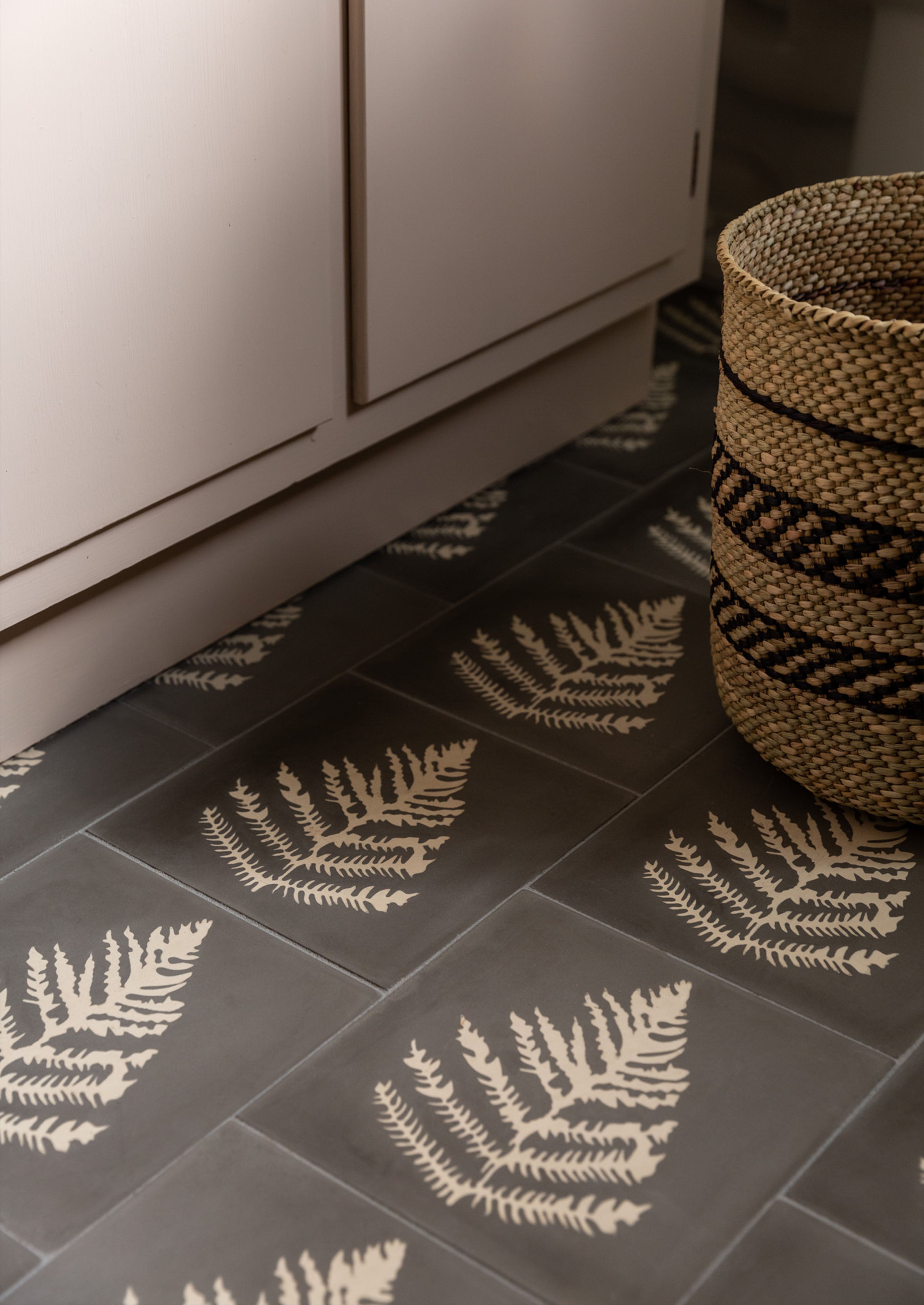 A floor with cement tiles with a fern design inspired by fashion designer erica tanov.