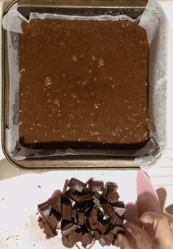 adding chocolate to brownie