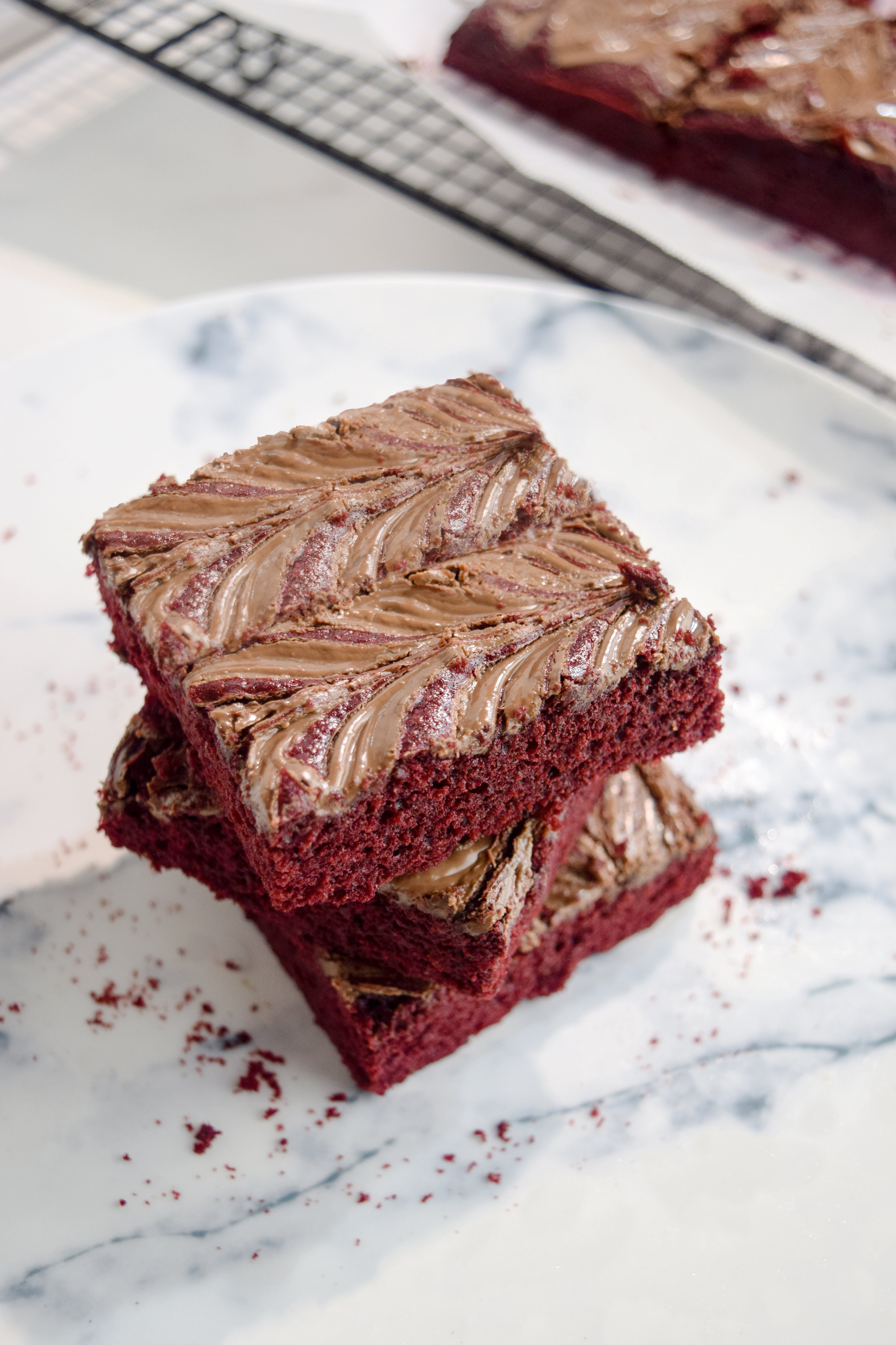 top view of nutella red velvet brownies on a marble plate