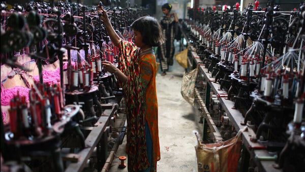 Child labor in a textile factory in Dhaka, Bangladesh