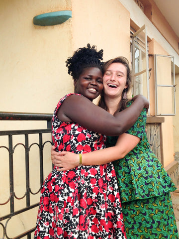 Amani intern hugging seamstress at amani uganda