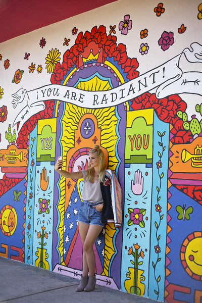 "You Are Radient" mural in North Park, California with fashion blogger Alyssaya posing in front of it.