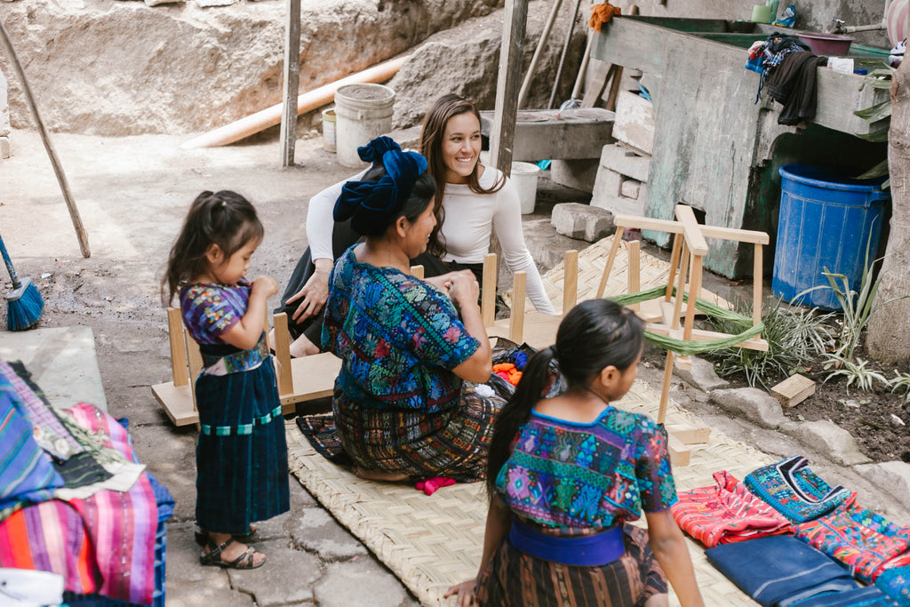 She Is Not Lost blogger Carina Otero converses joyfully with long term artisan partner Teresa and her family, weaving tours, artisan home visits, weaving workshops, ethical travel programs, ethical travel bloggers 