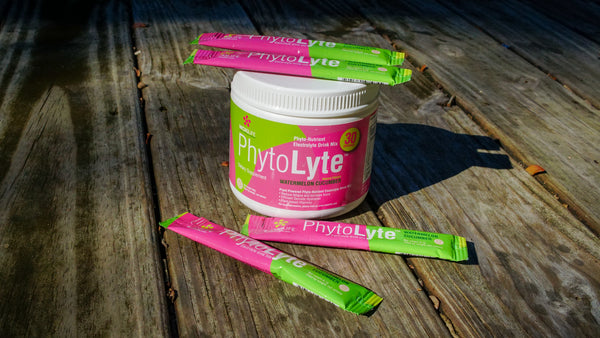 PhytoLyte Tub and Stickpack single servings on wood deck outdoors