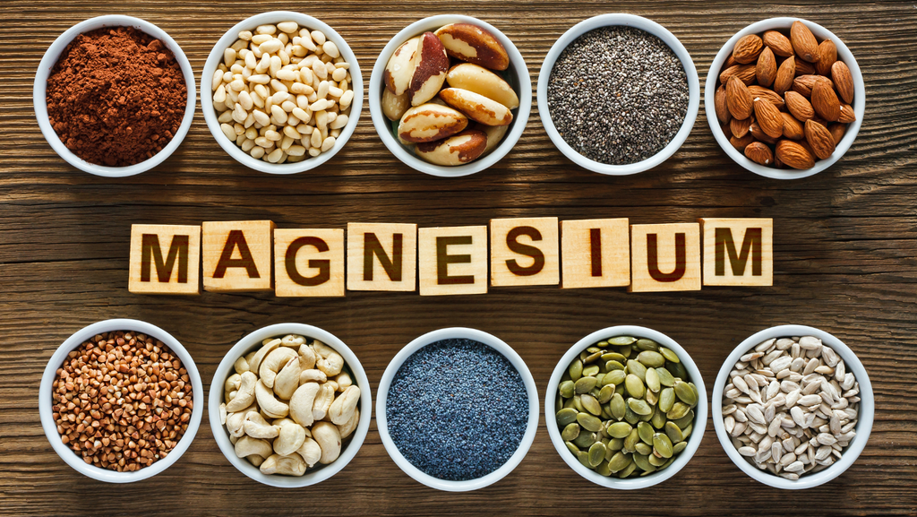 Magnesium spelled out in wooden blocks and cups of magnesium rich food sources.png