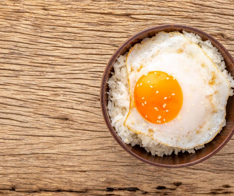 a soft boiled egg in a bowl placed on a table.