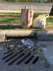 Bags of trash collected and a clean drain