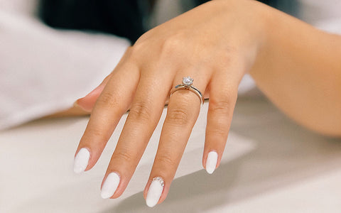 Woman's Manicured Hand With Engagement Ring