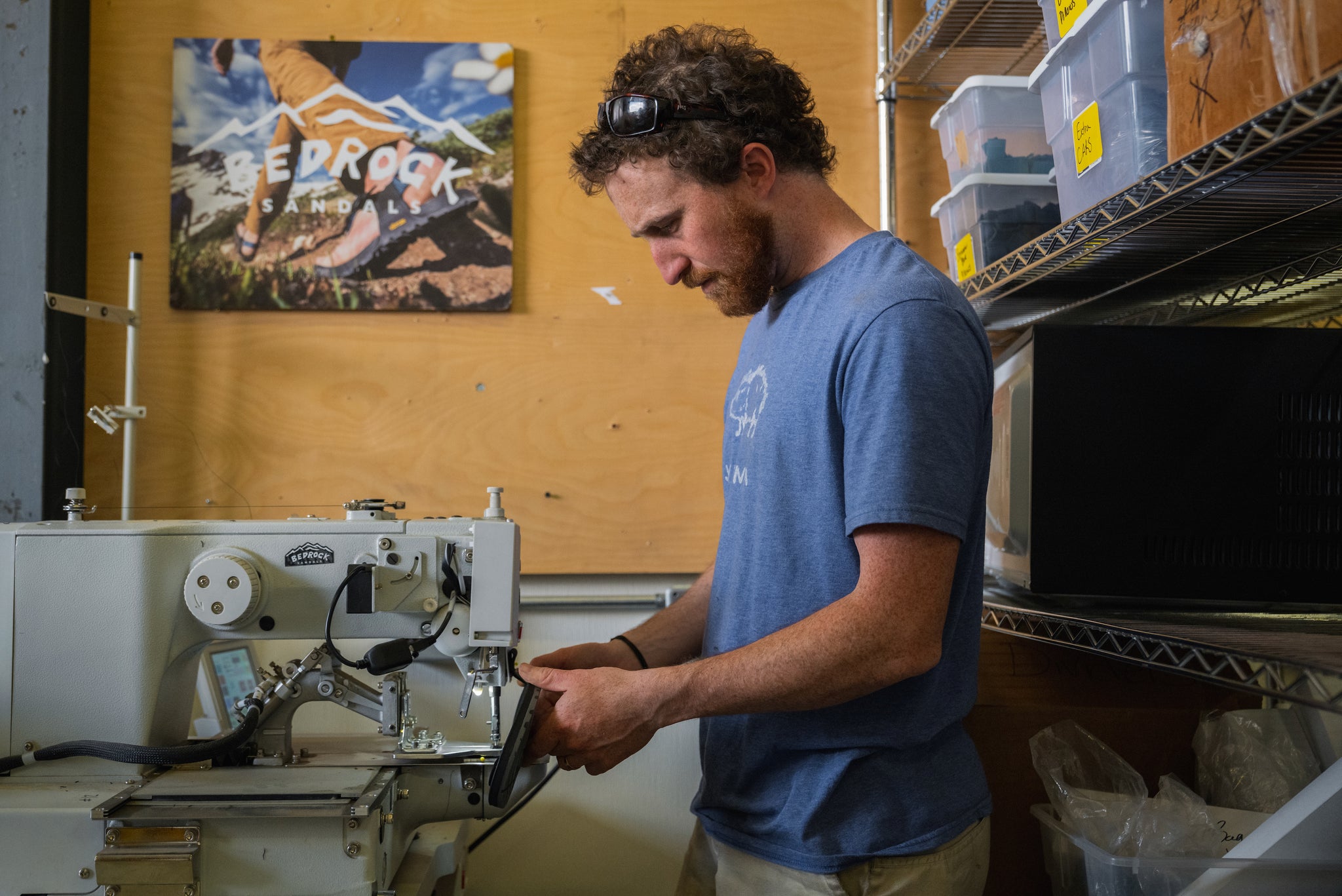 Person working on sewing machine to repair sandals