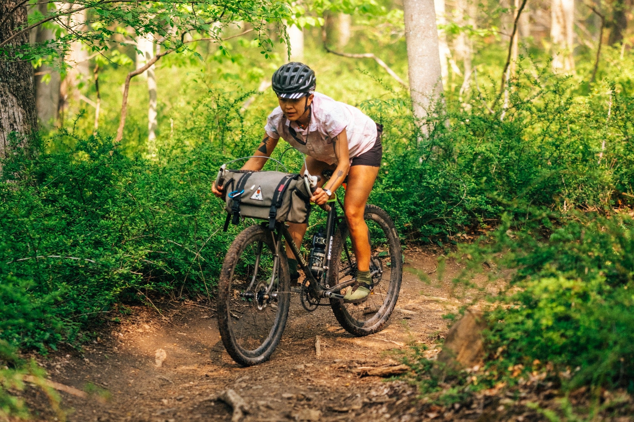 A person trail riding their bike wearing Bedrock Split toe socks and sandals