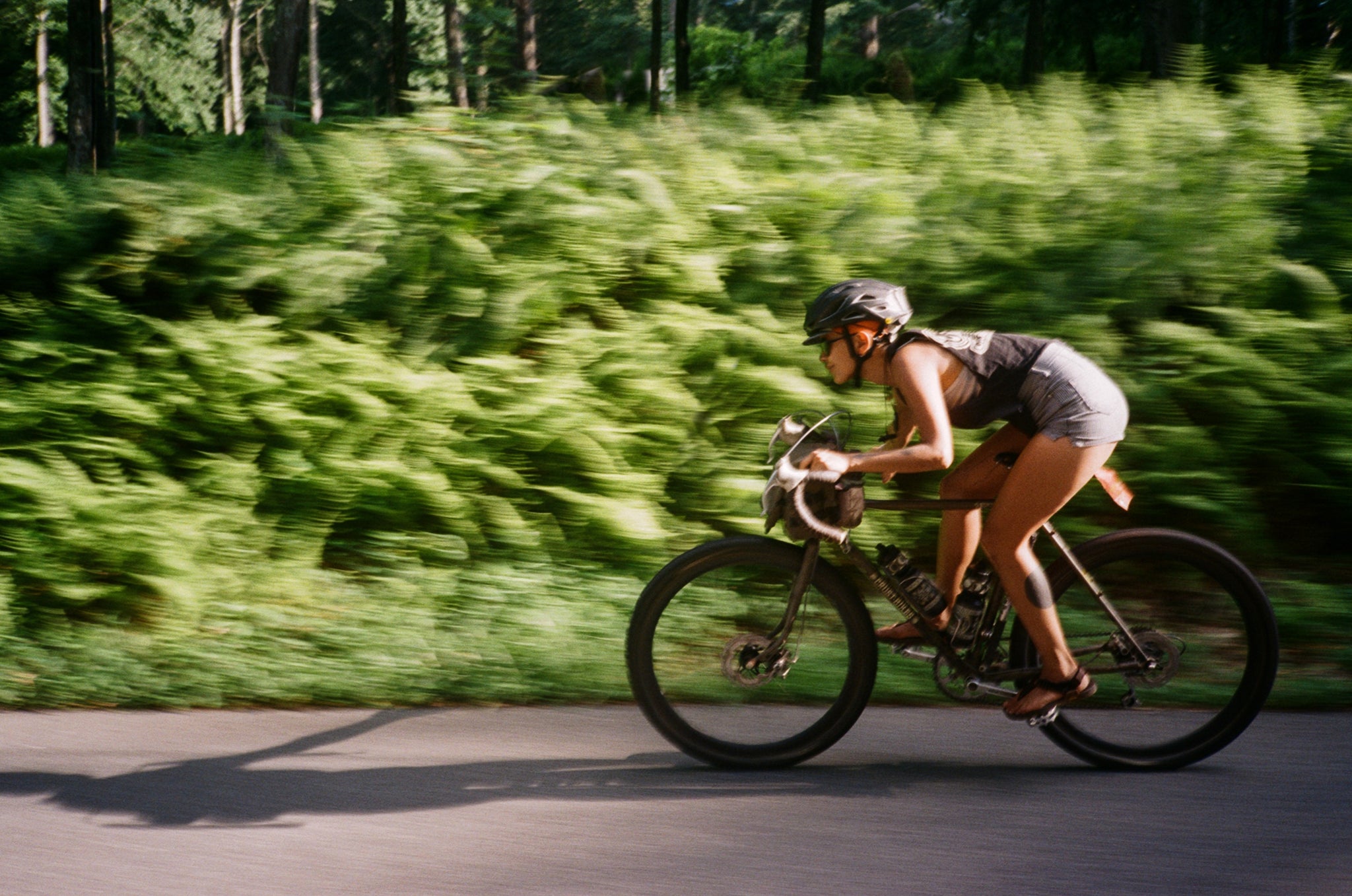 A person crouched on their bike, going fast