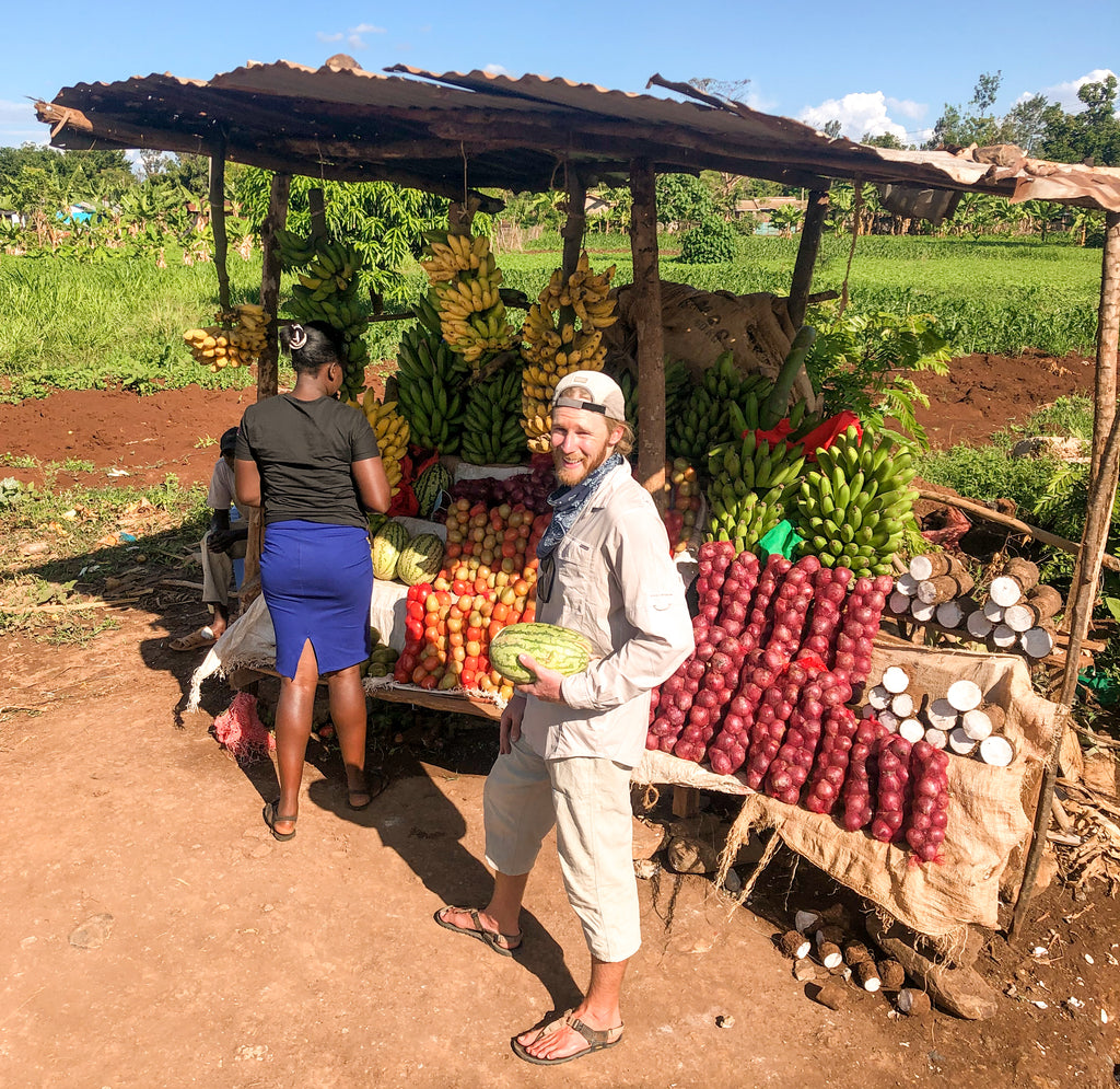 Person holding fruit in roadside stand