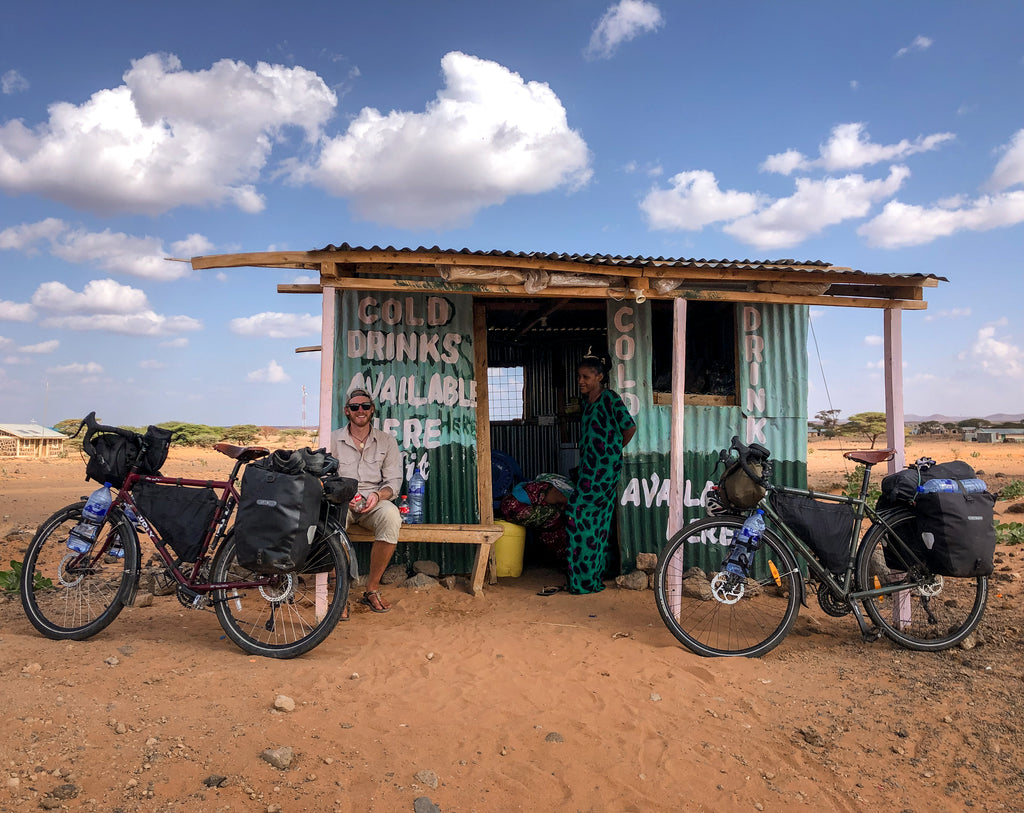 Cyclist at roadside stall in Africa