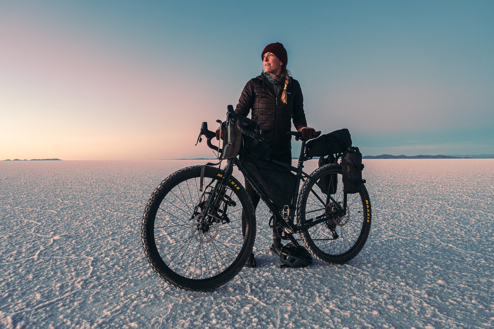 Bicyclist posing on salt flat with bike