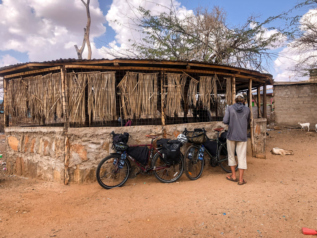 Person in African village bike touring